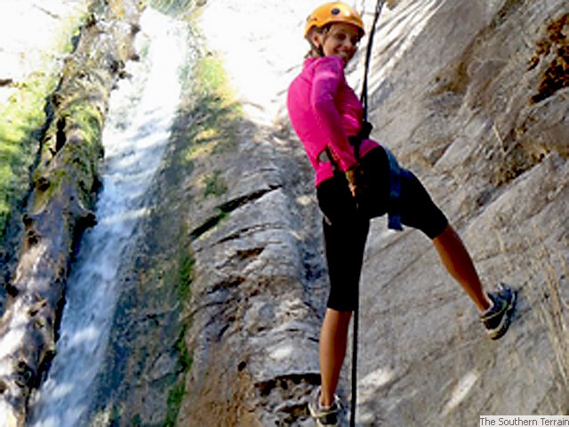 Rapelling next to waterfall